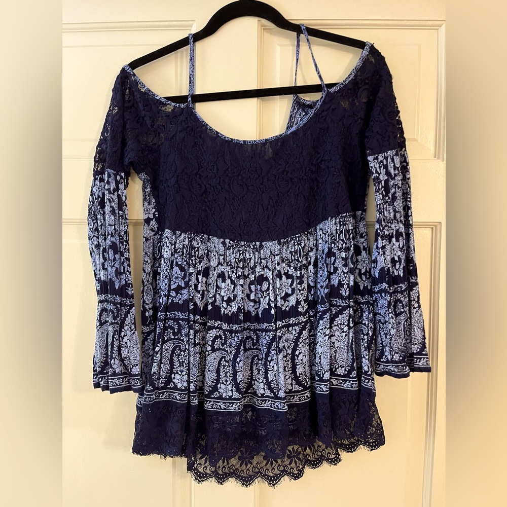 Navy blue cold shoulder bell sleeve top with lace detail.